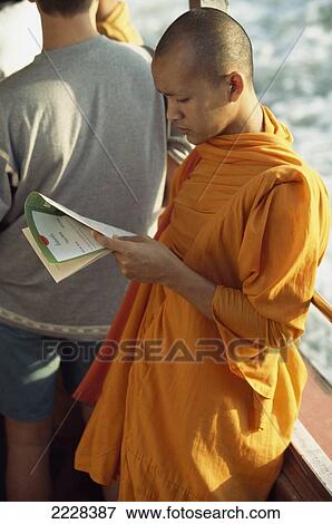 Stock Photo - Monk Read On The River Ferry, Bangkok, Thailand.. Fotosearch