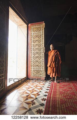 Monk standing in Wat Bo; Siem Reap, Cambodia View Large Photo Image Stock Photo - Monk standing in Wat Bo; Siem Reap, Cambodia. Fotosearch
