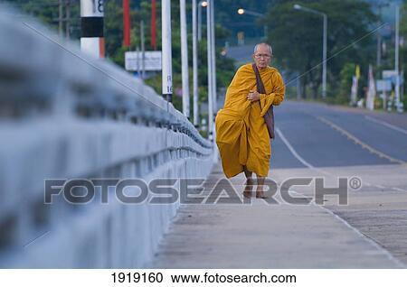 Stock Image - Monk Walking On Road Sidewalk. Fotosearch