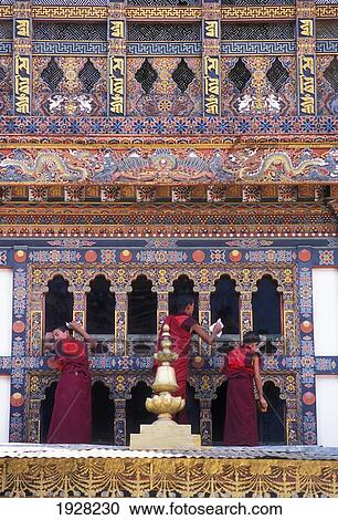 Stock Image - Monks Cleaning Windows At Monastery; Punakha, Bhutan. Fotosearch