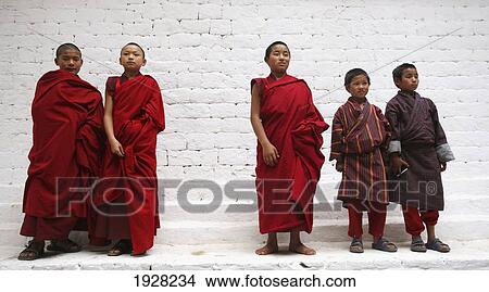 Picture - Monks Standing By Wall, Punakha, Bhutan. Fotosearch