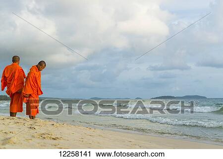 Monks standing on the sand at the water's edge of Serendipity Beach; Sihanoukville, Cambodia View Large Photo Image Stock Image - Monks standing on the sand at the water's edge of Serendipity Beach; Sihanoukville, Cambodia. Fotosearch