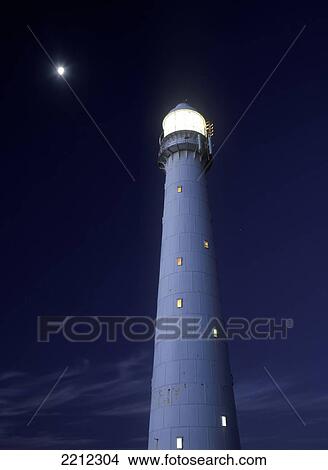Picture - Moon above lighthouse at dusk, Kommetjie, Cape peninsula; Cape Town, South Africa. Fotosearch