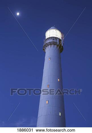 Stock Image - Moon Above Lighthouse At Dusk. Fotosearch