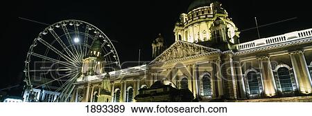 Stock Photo - Moon Rising Behind Big Wheel And Belfast City Hall. Fotosearch