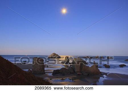 Stock Photography - Moon Set Over Rock Formations Reflecting In Tide Pools At Low Tide, Bandon Beach; Oregon, United States Of America. Fotosearch