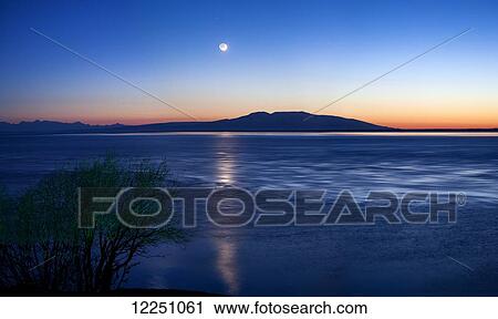 Moon setting over Mt. Susitna, also known as Sleeping Lady, West of Anchorage; Alaska, United States of America View Large Photo Image Stock Image - Moon setting over Mt. Susitna, also known as Sleeping Lady, West of Anchorage; Alaska, United States of America. Fotosearch