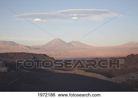 Stock Photograph - Moon Valley With The Licancabur Volcano In The Background At Sunset, San Pedro De Atacama, Antofagasta Region, Chile. Fotosearch