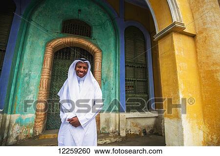 Stock Image - Moor Saudi standing in a doorway of old building; Taif, Saudi Arabia. Fotosearch