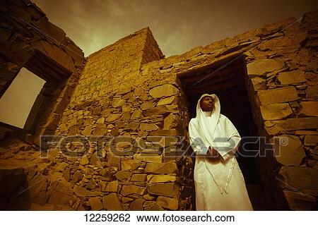 Stock Image - Moor Saudi standing in a doorway of old building; Taif, Saudi Arabia. Fotosearch