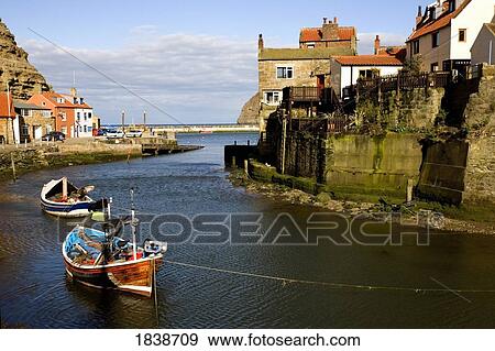 Moored Boats In Staithes; North Yorkshire, England, Uk View Large Photo Image Stock Photo - Moored Boats In Staithes; North Yorkshire, England, Uk. Fotosearch