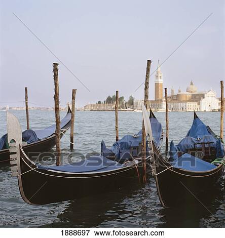 Stock Photo - Moored Gondolas On Canal By St Mark ' S Square With San Maggiore In The Distance. Fotosearch
