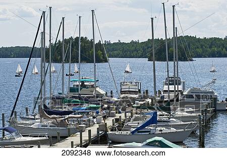 Moored Sailboats At Dock In Northwestern Ontario; Lake Of The Woods Ontario Canada View Large Photo Image Stock Photo - Moored Sailboats At Dock In Northwestern Ontario; Lake Of The Woods Ontario Canada. Fotosearch