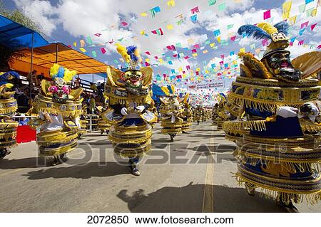 Morenada Dancers Wearing Elaborate Masks And Costumes In The Procession Of The Carnaval De Oruro, Oruro, Bolivia View Large Photo Image Stock Image - Morenada Dancers Wearing Elaborate Masks And Costumes In The Procession Of The Carnaval De Oruro, Oruro, Bolivia. Fotosearch