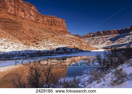 Stock Photography - Morning light on the canyon walls in winter in Colorado Riverway Recreation Area near Moab; Utah, United States of America. Fotosearch