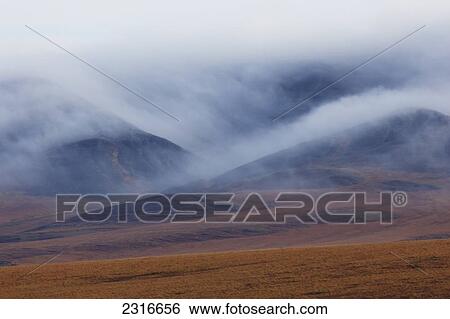 Morning Mist Rolls Over The Richardson Mountains Along The Dempster Highway; Yukon Canada View Large Photo Image Stock Photograph - Morning Mist Rolls Over The Richardson Mountains Along The Dempster Highway; Yukon Canada. Fotosearch