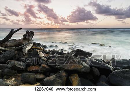 Morning surf and wet rocks along the coast; Wailua, Kauai, Hawaii, United States of America View Large Photo Image Stock Photo - Morning surf and wet rocks along the coast; Wailua, Kauai, Hawaii, United States of America. Fotosearch
