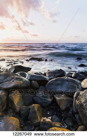 Stock Photo - Morning surf and wet rocks along the coast; Wailua, Kauai, Hawaii, United States of America. Fotosearch