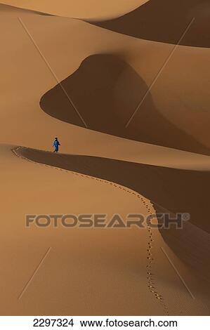 Morocco, Berber 'Blue man' walking across sand dunes in Erg Chebbi area; Sahara Desert near Merzouga View Large Photo Image Picture - Morocco, Berber 'Blue man' walking across sand dunes in Erg Chebbi area; Sahara Desert near Merzouga. Fotosearch