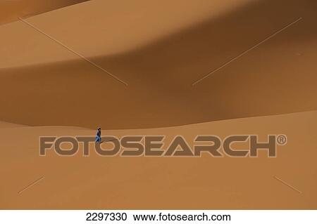 Morocco, Berber 'Blue man' walking across sand dunes in Erg Chebbi area; Sahara Desert near Merzouga View Large Photo Image Stock Image - Morocco, Berber 'Blue man' walking across sand dunes in Erg Chebbi area; Sahara Desert near Merzouga. Fotosearch