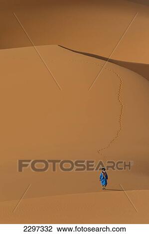 Morocco, Berber 'Blue man' walking across sand dunes in Erg Chebbi area; Sahara Desert near Merzouga View Large Photo Image Stock Image - Morocco, Berber 'Blue man' walking across sand dunes in Erg Chebbi area; Sahara Desert near Merzouga. Fotosearch