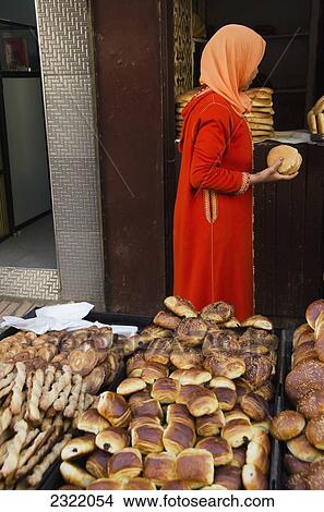 Picture - Morocco, Casablanca, Old Medina, Female buying bread. Fotosearch