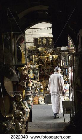 Stock Image - Morocco, Casablanca, Senior man walking through among items for sale in Quartier Habbous. Fotosearch