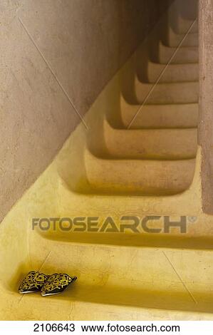 Stock Image - Morocco, Dar Ahlam Hotel; Skoura, Pair of babouche shoes (Moroccan slippers) on stairs. Fotosearch