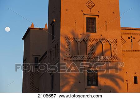 Morocco, Date palm shadow on wall of main kasbah of Dar Ahlam Hotel at dusk; Skoura View Large Photo Image Stock Photo - Morocco, Date palm shadow on wall of main kasbah of Dar Ahlam Hotel at dusk; Skoura. Fotosearch