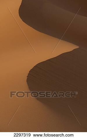 Stock Photo - Morocco, Detail of sand dunes at dawn in Erg Chebbi area; Sahara Desert near Merzouga. Fotosearch