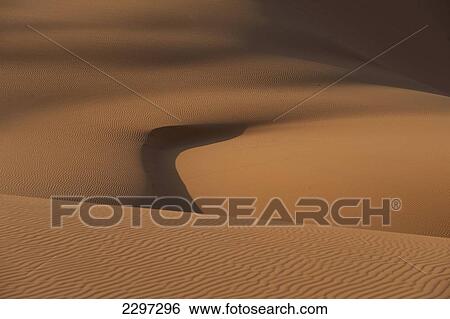 Stock Photograph - Morocco, Erg Chebbi area; Sahara Desert near Merzouga, Patterns at dawn in sand dunes. Fotosearch