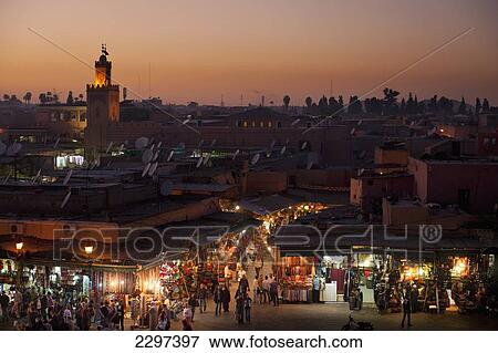 Morocco, Looking over entrance to souks at dusk at edge of Djemaa El Fna; Marrakesh View Large Photo Image Stock Photo - Morocco, Looking over entrance to souks at dusk at edge of Djemaa El Fna; Marrakesh. Fotosearch