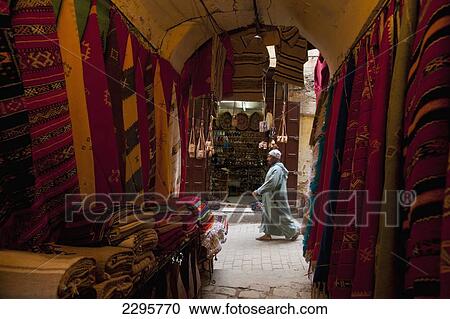Morocco, Looking past clothes for sale in narrow passageway to man walking down alley; Fez View Large Photo Image Stock Image - Morocco, Looking past clothes for sale in narrow passageway to man walking down alley; Fez. Fotosearch