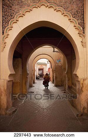 Morocco, Man on moped going through arches in alleyway in Medina of Marrakesh; Marrakesh View Large Photo Image Stock Image - Morocco, Man on moped going through arches in alleyway in Medina of Marrakesh; Marrakesh. Fotosearch