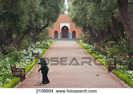 Morocco, Man sweeping garden alley; Marrakech View Large Photo Image Picture - Morocco, Man sweeping garden alley; Marrakech. Fotosearch