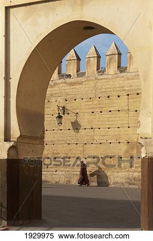 Stock Photography - Morocco, Man walking on street near Royal Palace; Fez. Fotosearch