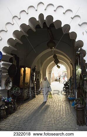 Morocco, Marrakech, Medina, Woman walking with shopping bag through covered corridor View Large Photo Image Stock Photo - Morocco, Marrakech, Medina, Woman walking with shopping bag through covered corridor. Fotosearch