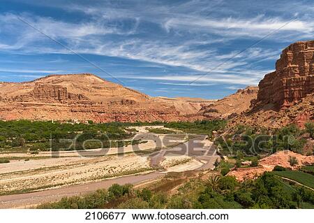 Stock Photo - Morocco, River and small village in background; Valley of Roses. Fotosearch