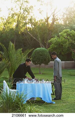 Morocco, Staff arranging table for breakfast in garden of Dar Ahlam Hotel; Skoura View Large Photo Image Stock Image - Morocco, Staff arranging table for breakfast in garden of Dar Ahlam Hotel; Skoura. Fotosearch