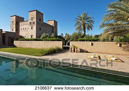 Morocco, Swimming pool and main Kasbah of Dar Ahlam hotel; Skoura View Large Photo Image Stock Photo - Morocco, Swimming pool and main Kasbah of Dar Ahlam hotel; Skoura. Fotosearch