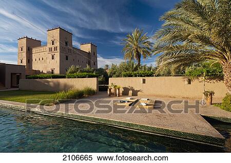 Morocco, Swimming pool of Dar Ahlam Hotel with main kasbah in background at dawn; Skoura View Large Photo Image Stock Photography - Morocco, Swimming pool of Dar Ahlam Hotel with main kasbah in background at dawn; Skoura. Fotosearch
