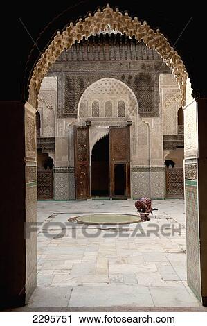 Stock Image - Morocco, Woman in courtyard of Medersa Bou Inania; Fez. Fotosearch