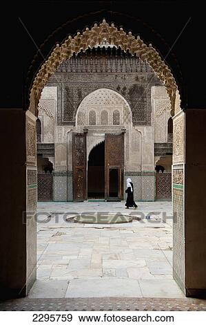 Morocco, Woman walking across courtyard of Medersa Bou Inania; Fez View Large Photo Image Stock Photo - Morocco, Woman walking across courtyard of Medersa Bou Inania; Fez. Fotosearch