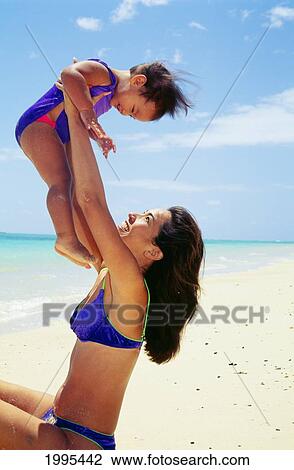 Mother And Baby Girl Play At Beach, Lifting Baby In Air, White Sand And Turquoise Water View Large Photo Image Stock Image - Mother And Baby Girl Play At Beach, Lifting Baby In Air, White Sand And Turquoise Water. Fotosearch