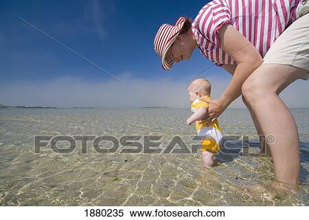 Mother And Baby In Shallow Waters Off The Beach, Low Angle View View Large Photo Image Stock Photography - Mother And Baby In Shallow Waters Off The Beach, Low Angle View. Fotosearch