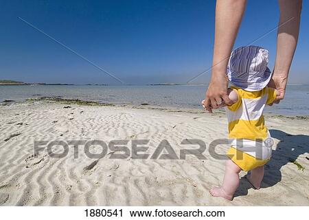 Stock Image - Mother And Baby On The Beach Of Plage Saint Marguerite, Low Angle View. Fotosearch
