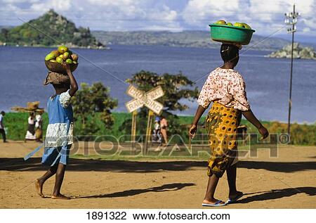 Stock Image - Mother And Daughter Carrying Fruit To Market Near Lake Victoria. Fotosearch