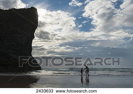 Mother and daughter dodging waves on beach at Bedruthan Steps; Cornwall, England View Large Photo Image Stock Image - Mother and daughter dodging waves on beach at Bedruthan Steps; Cornwall, England. Fotosearch