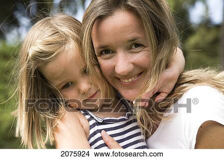 Picture - Mother And Daughter Hugging; Ontario Canada. Fotosearch