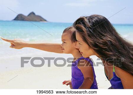 Mother And Daughter On Beach, Pointing Out To Ocean View Large Photo Image Stock Image - Mother And Daughter On Beach, Pointing Out To Ocean. Fotosearch